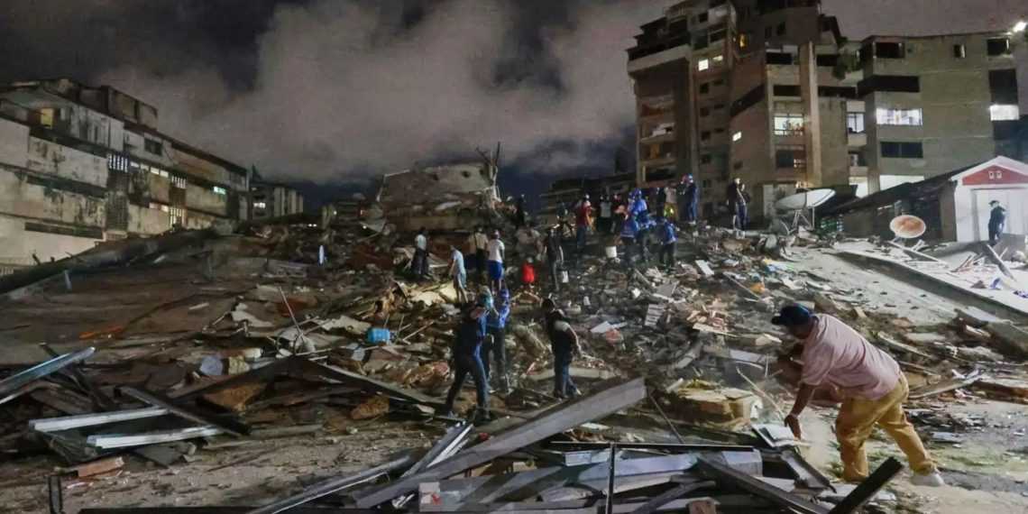 Nighttime rescue scene in a collapsed city block: rubble, damaged buildings, and people searching for survivors.