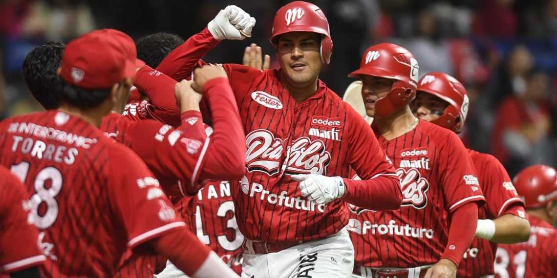 Red-uniform baseball players celebrate together on the field, with one central player raising a fist in triumph as teammates join in cheers.